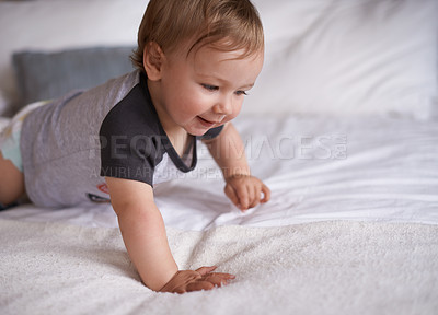 Buy stock photo Boy, baby and learning to crawl in home, bed and kid for motor skills in bedroom on weekend. Child development, happy toddler and calm or comfortable, wellness and curious for health and growth