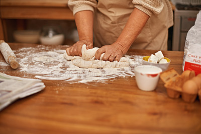 Buy stock photo A cropped view of hands working the dough while baking in a kitchen