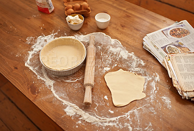 Buy stock photo Preparation, counter and ingredients for dough or pastry with no people, ready for filling and baking or cooking for easter holiday. Books, recipes and pan for sweet handmade pie for dessert or snack