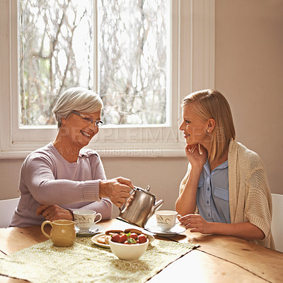 Buy stock photo Family, mother and daughter with tea for drink, relaxing and communication with conversation. Happy people, women and smile with coffee at home in table or kitchen, talking and laughing in house