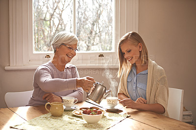 Buy stock photo Happy, woman and grandmother with tea in home for brunch, bonding or visit in retirement. Senior, grandma and girl on coffee break with food, conversation and pouring liquid with steam in morning