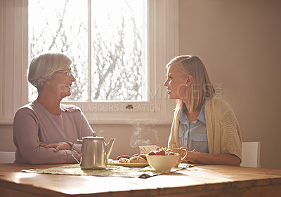 Buy stock photo Talking, tea and grandmother with woman in home for brunch, bonding or visit in retirement. Senior, grandma and girl on coffee break with food, conversation and relax on holiday or vacation morning