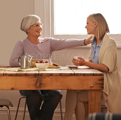 Buy stock photo House, senior and comfort to daughter, visit and elderly mom in dining table with food for breakfast, coffee and snacks with mother. Female person, smile and happiness with parent in family home
