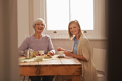 Buy stock photo Portrait, happy woman and senior mother drinking tea at breakfast, bonding and smile in house. Face, elderly mom and daughter with coffee cup at table, food and funny family laughing at home together