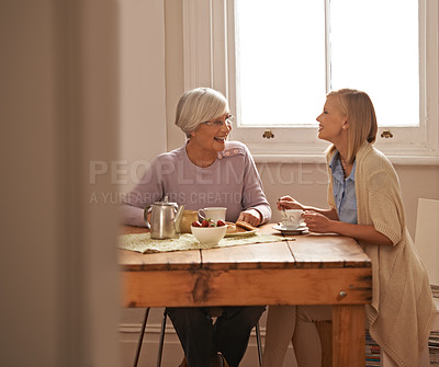 Buy stock photo Family, happy woman and senior mother drinking tea at breakfast, bonding and smile. Laughing, elderly mom and daughter with coffee cup at table, food and listening to funny story at home together