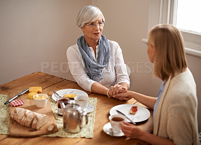 Buy stock photo Senior mom, daughter and home with conversation in table for bonding, support and visit. Holding hands, family and meal with tea, food and chat on breakfast together with care, smile and love 