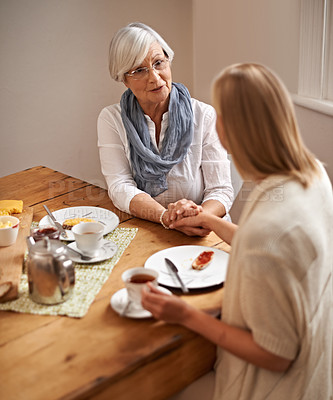 Buy stock photo Mother, daughter and home with holding hands in table on lunch for bonding, support and visit. House, family and tea with food for conversation on break, leisure and happiness for coffee and care.