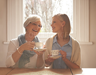 Buy stock photo Family, happy woman and senior mother drinking tea at breakfast, bonding and smile in house. Laughing, elderly mom and daughter with coffee cup at table, conversation or funny people at home together