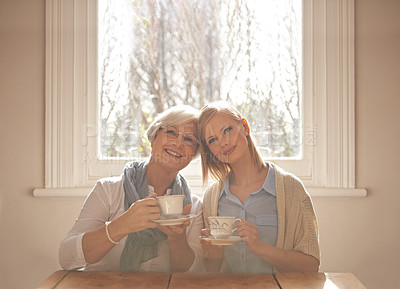 Buy stock photo Portrait, happy woman and elderly mother drinking tea at breakfast in the morning, bonding and smile in house. Face, senior mom and daughter with coffee cup at table, love and family at home together