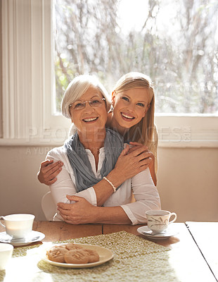 Buy stock photo Family home, retirement and daughter hug mom for breakfast in dining table, coffee and snacks. Female person, smile and happiness with mother in house, elderly and visit from girl, tea and biscuits