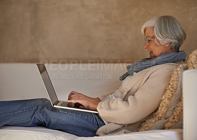 Buy stock photo Senior woman, laptop and couch in home, technology or internet for connection. Computer, media or website for elderly blogger and writer, living room and typing happy female person in family house