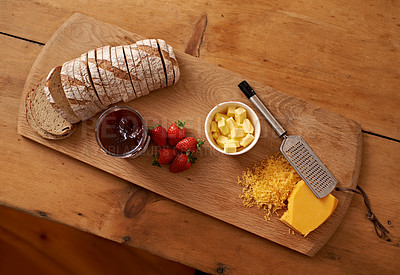 Buy stock photo Breakfast, board and cheese with jam, bread and fresh strawberry for diet, nutrition and gourmet morning snack. Food, fruit and high angle of sweet, savory and delicious rustic brunch on charcuterie.