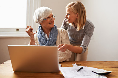 Buy stock photo Granddaughter, grandmother and helping with laptop for online payment, finance and technology with advice on budget. Women pay bills, life insurance or tax paperwork with retirement and assistance