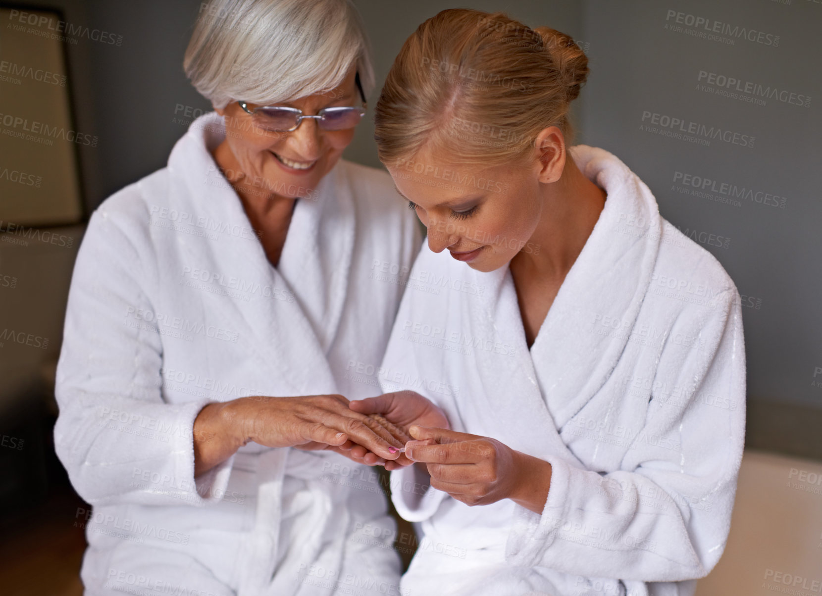 Buy stock photo Senior mother, woman and manicure at home, cosmetics and spa for bonding and relaxation. Parent, daughter and nail polish with bath, guidance and support with beauty treatment or makeup with robe
