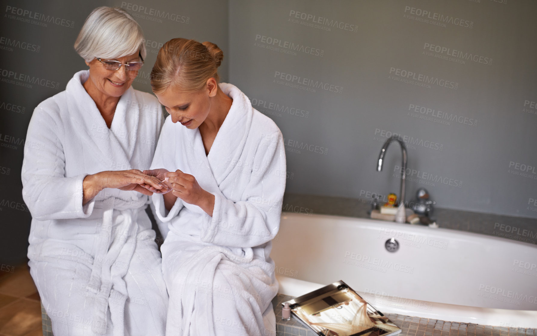 Buy stock photo Mother, spa and manicure with daughter, bath and senior woman for bonding and relaxation. Parent, robe and nail polish with cosmetics, guidance and support with beauty treatment or pamper and glasses
