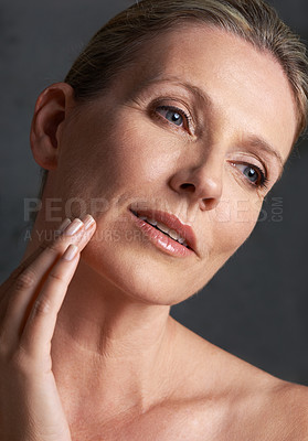 Buy stock photo Face, skincare and memory with mature woman in studio on gray background for aesthetic wellness. Beauty, facial and thinking with natural skin person at spa for antiaging cosmetics or treatment