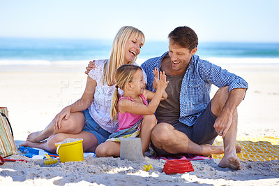 Buy stock photo Family, beach and young girl on vacation, seaside and ocean with sand castle for bonding time. Holiday, overseas and summer season with parents, daughter and sunshine for happy memories in Hawaii