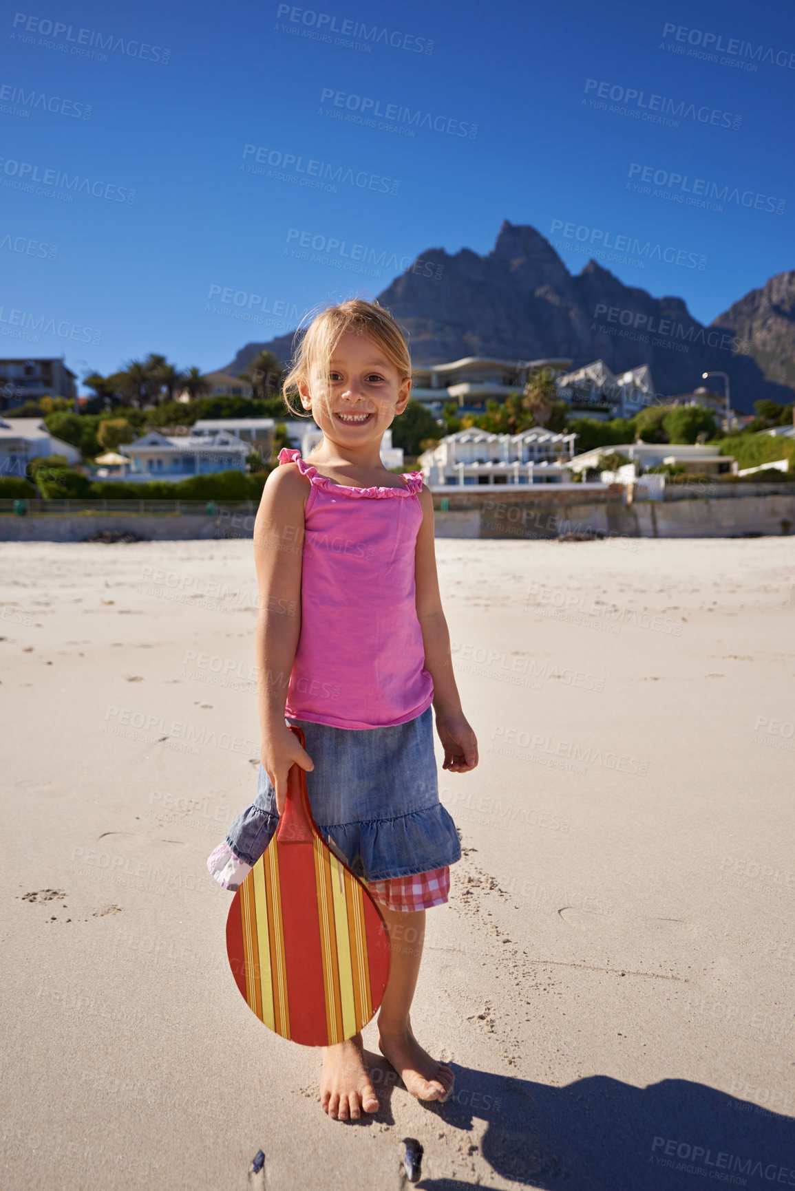 Buy stock photo Happy girl, portrait and beach with paddle bat for game, playful summer or outdoor holiday weekend in nature. Female person, child or kid with smile for fun day or activity by ocean coast on mockup