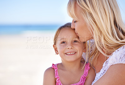 Buy stock photo Smile, mother and kiss kid at beach on holiday, summer or love on vacation at sea. Face, mom and happy girl at ocean for adventure, travel and family bonding together outdoor in nature on mockup