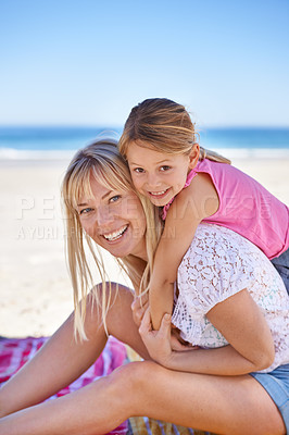 Buy stock photo Portrait, mother and smile of kid on beach for vacation, summer or holiday with piggyback on blanket. Face, mom or happy girl at ocean for adventure, travel or family bonding together on mockup space