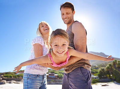 Buy stock photo Shot of a happy young family being playful at the beach
