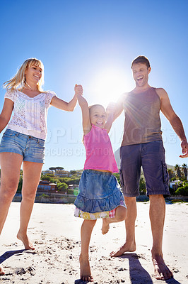 Buy stock photo Parents, swing and playing with child at beach in portrait with care, love or bonding in summer on holiday. Father, mother and daughter with games, connection or holding hands in sunshine on vacation