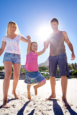 Buy stock photo Parents, swing and holding hands with child at beach in portrait with care, love or bonding in summer on holiday. Father, mother and daughter with games, connection or playing in sunshine on vacation