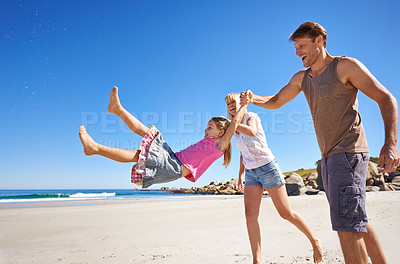Buy stock photo Holding hands, swing and happy family at a beach with love, support and care while bonding in nature. Freedom, travel and kid with parents at the ocean for morning games, fun or adventure at the sea