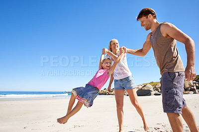 Buy stock photo Happy family, swing and holding hands at a beach with love, support and care while bonding in nature. Freedom, travel and kid with parents at the ocean for morning games, fun or adventure at the sea