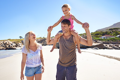 Buy stock photo Happy family, beach and piggyback with child for fun summer, holiday or outdoor weekend in nature. Mother, father and little girl with ride on shoulders in freedom, bonding or love by the ocean coast