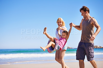 Buy stock photo Family, child and bonding by swinging on beach, love and trust or having fun on summer holiday. Happy parents, daughter and playing game on tropical vacation, outdoors and smile on mockup space
