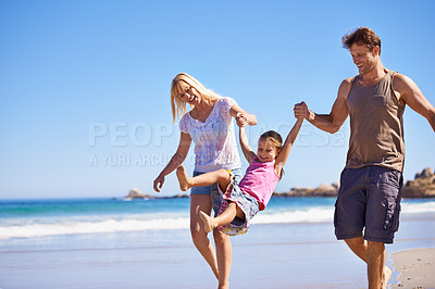 Buy stock photo Family, child and fun by swinging on beach, love and trust or travel on summer holiday. Happy parents, daughter and playing game on tropical vacation, outdoors and smile on mockup space by blue sky