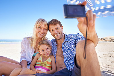Buy stock photo Happy family, beach and relax with selfie for photo, moment or photography in outdoor nature. Mother, father and child with smile for picture, capture or bonding memory together on the ocean coast