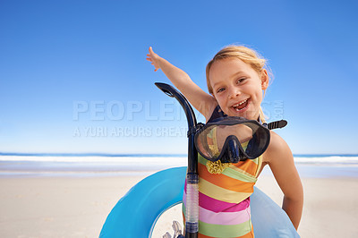 Buy stock photo Portrait of a cute little girl standing on the beach with her snorkeling gear and swimming tube