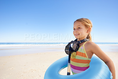 Buy stock photo Girl, inflatable and goggles or tube at beach, ocean and equipment for swimming on holiday. Female person, happy child and water on tropical vacation in outdoors, sand and blue sky for mockup space