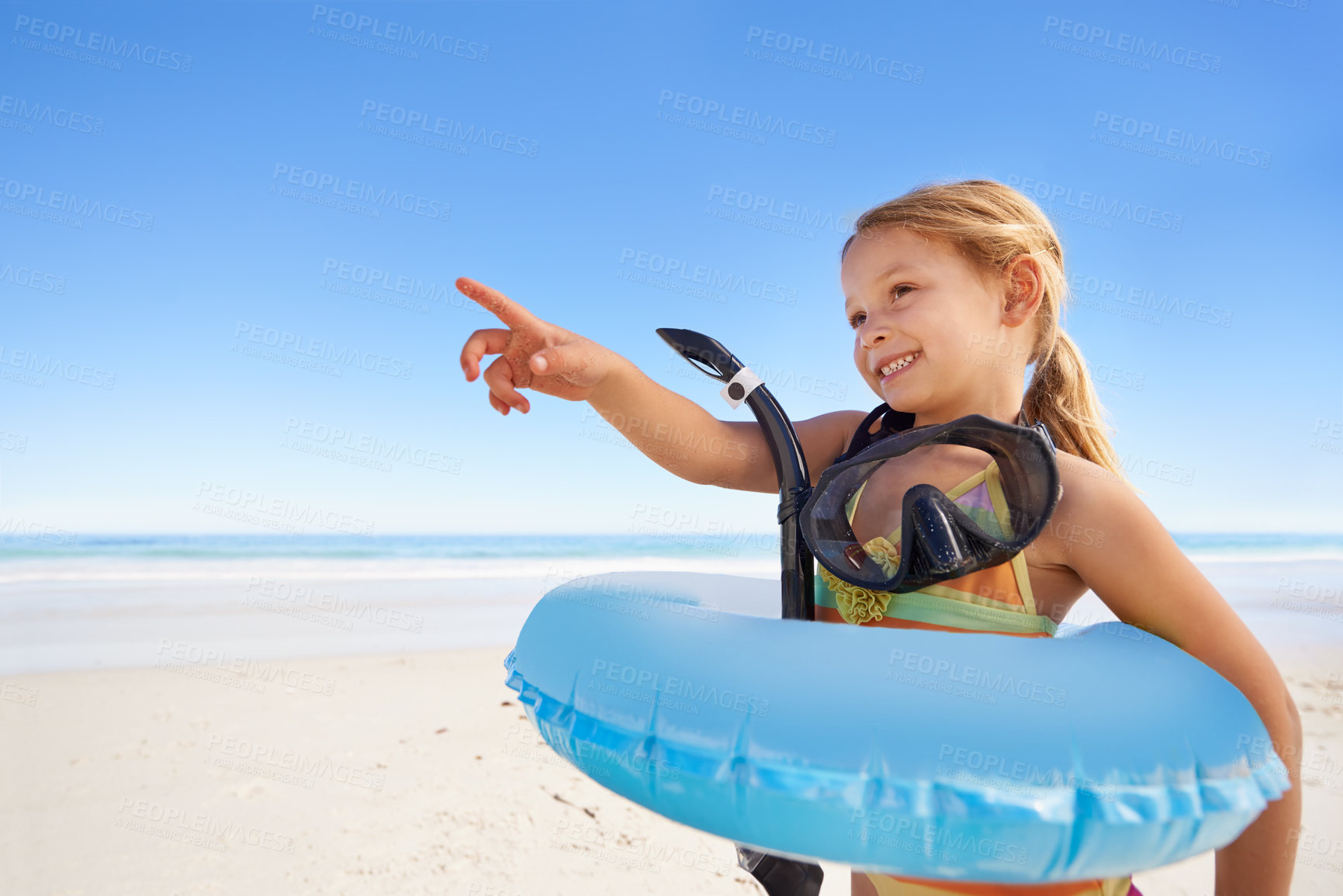 Buy stock photo Girl, smile and goggles for swimming at beach, pointing and equipment for water on holiday. Female person, child and happy on tropical vacation in outdoors, inflatable and blue sky for mockup space