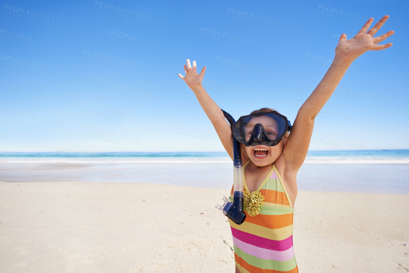 Buy stock photo Girl, happy and goggles for celebration at beach, energy and equipment for snorkeling on holiday. Female person, child and victory on tropical vacation in outdoor, sand and blue sky for mockup space