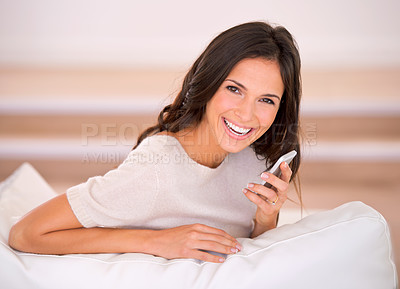 Buy stock photo Woman, phone call and speaker with smile on sofa in living room for talking, portrait and chat in home. Person, cellphone and happy for mobile network with connection on lounge at house in Barcelona
