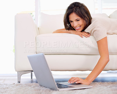 Buy stock photo Woman, lying and relax on sofa with laptop on floor for scroll, search or streaming in home living room. Girl, person and reading on couch with computer on carpet for movies, show or happy in house