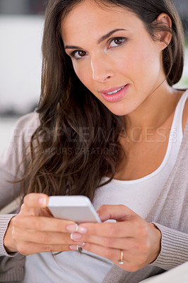 Buy stock photo Woman, phone and texting on sofa in portrait for communication, web chat or notification in living room. Girl, person and smartphone with mobile application, typing or scroll in home on social media