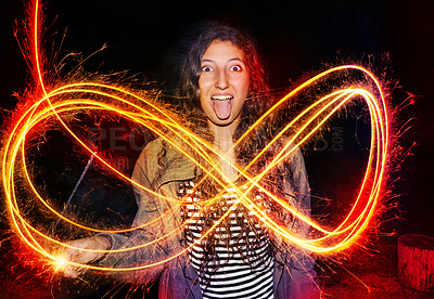 Buy stock photo Cropped shot of a young girl making patterns in the air with sparklers