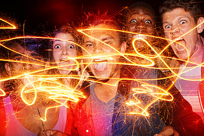 Buy stock photo Portrait, friends and party at night with fireworks, crazy and celebration with neon lights for fun. Young people, screaming and silly face by sparklers for patterns and bonding together on new year