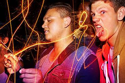 Buy stock photo Group, teens and playing with fireworks, vacation and funny with happiness and silly with weekend break. Friends, outdoor and people with sparklers and holiday with fun and goofy with New Years party