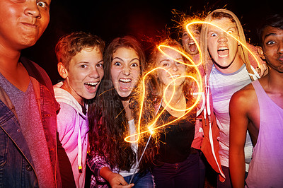 Buy stock photo Fireworks, night and portrait of friends for party, festival and new years eve celebration at night. Lights, excited and men and women with sparkles for festive vacation, holiday and event together