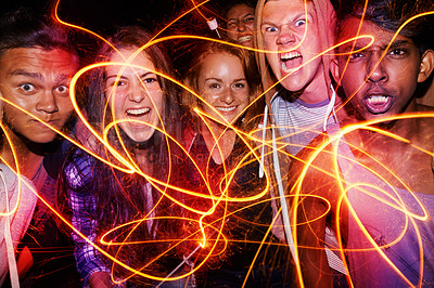 Buy stock photo Portrait, party and crazy friends with fireworks on dark background together for new year celebration. Face, energy or shouting with group of young teenage boys and girls at concert, club or rave