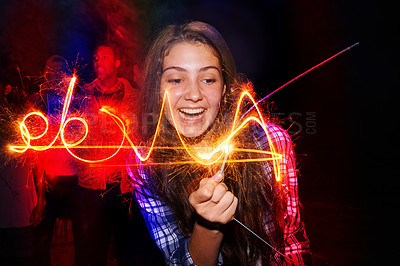 Buy stock photo Cropped shot of a teenage girl playing with a firework