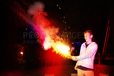 Buy stock photo Cropped shot of a teenage boy playing with a firework