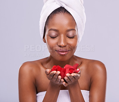 Buy stock photo Skincare, towel and black woman with petals in studio with cosmetics, wellness and cleaning. Salon aesthetic, dermatology and isolated person for natural skin, beauty and facial on gray background