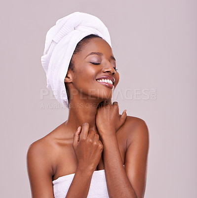 Buy stock photo An isolated studio shot of a beautiful young woman wearing a towel on her head