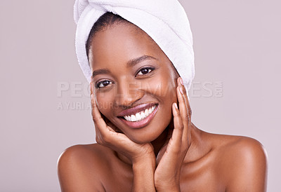 Buy stock photo An isolated studio portrait of a beautiful young woman wearing a towel on her head